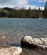 [Snowy Range lake 2] - clear water, lake, rocks, pine trees, evergreens, mountains